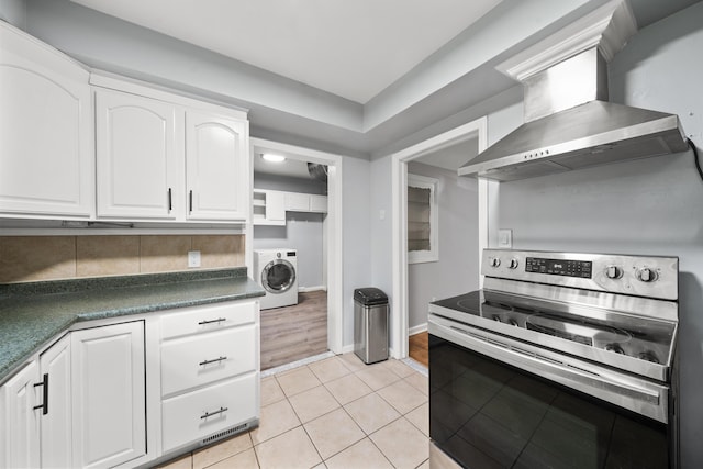 5615 Carlburt St, West Bloomfield, MI 48322 - kitchen featuring electric stove, wall chimney range hood, washer / clothes dryer, dark countertops, and white cabinets