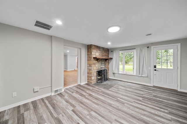 5615 Carlburt St, West Bloomfield, MI 48322 - unfurnished living room with light wood-style flooring, a stone fireplace, and recessed lighting