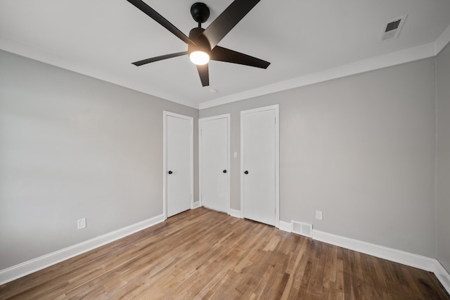 5615 Carlburt St, West Bloomfield, MI 48322 - unfurnished bedroom featuring wood finished floors and ceiling fan