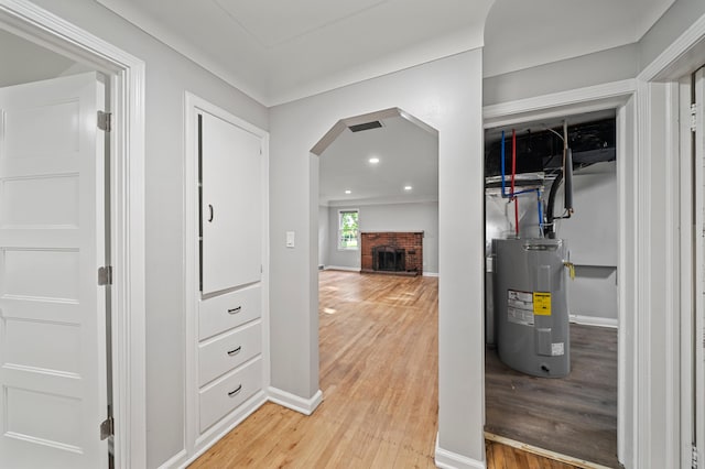 5615 Carlburt St, West Bloomfield, MI 48322 - hallway featuring electric water heater, arched walkways, light wood-style flooring, and recessed lighting