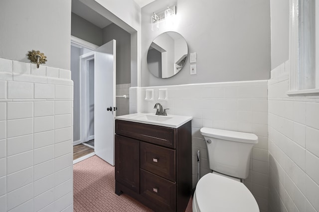 5615 Carlburt St, West Bloomfield, MI 48322 - bathroom with tile walls, vanity, wainscoting, and tile patterned flooring