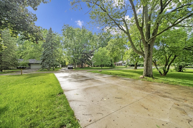 5615 Carlburt St, West Bloomfield, MI 48322 - view of concrete surface featuring view of wooded area
