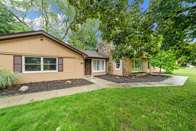 5615 Carlburt St, West Bloomfield, MI 48322 - view of front of house featuring a front yard and stone siding