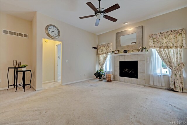 333 Sherman Ct, Ortonville, MI 48462 - unfurnished living room featuring carpet flooring, plenty of natural light, a tile fireplace, and a ceiling fan