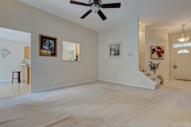 333 Sherman Ct, Ortonville, MI 48462 - unfurnished living room with light carpet, stairway, and ceiling fan