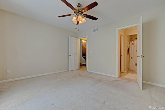 333 Sherman Ct, Ortonville, MI 48462 - unfurnished bedroom with light colored carpet, connected bathroom, a spacious closet, and a ceiling fan