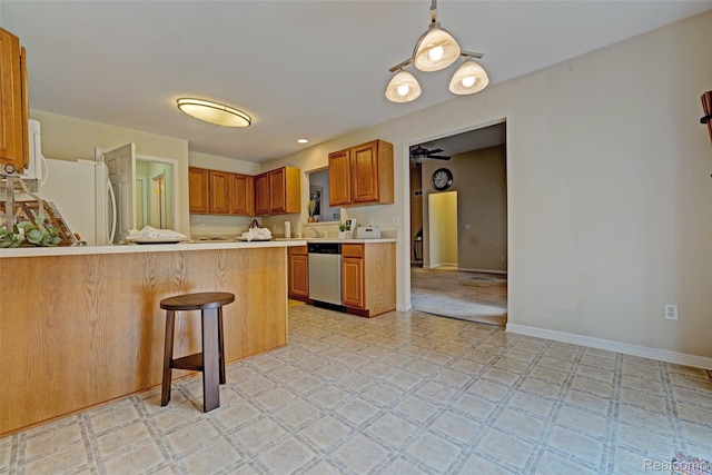 333 Sherman Ct, Ortonville, MI 48462 - kitchen with dishwasher, light countertops, a peninsula, light flooring, and freestanding refrigerator