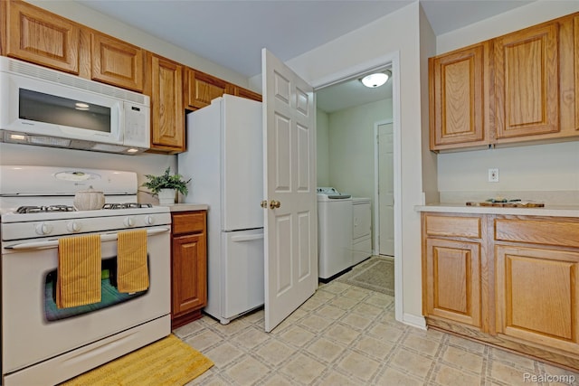 333 Sherman Ct, Ortonville, MI 48462 - kitchen with white appliances, washing machine and clothes dryer, light countertops, and light flooring