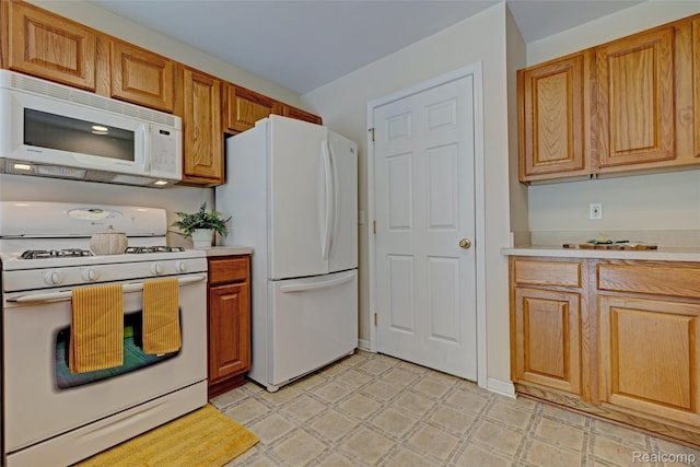 333 Sherman Ct, Ortonville, MI 48462 - kitchen with white appliances, light countertops, brown cabinets, and light flooring