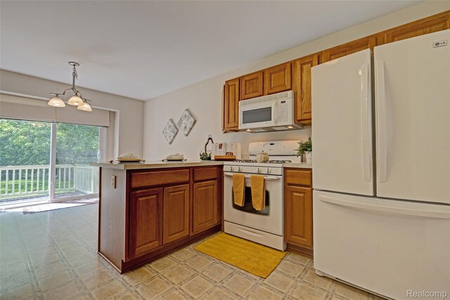 333 Sherman Ct, Ortonville, MI 48462 - kitchen featuring white appliances, light countertops, a peninsula, brown cabinetry, and a chandelier