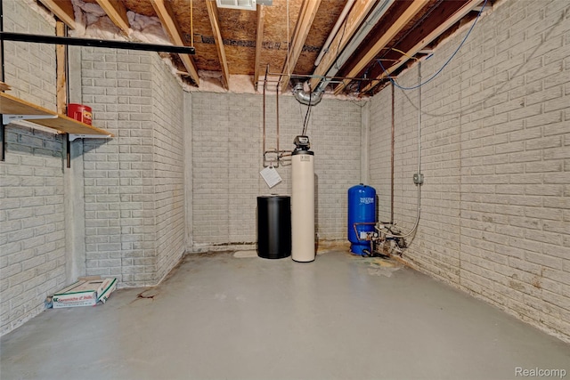 333 Sherman Ct, Ortonville, MI 48462 - unfinished below grade area with a water pressure tank, a water softener system, and brick wall