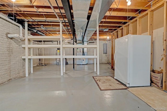 333 Sherman Ct, Ortonville, MI 48462 - unfinished basement with freestanding refrigerator, electric panel, and brick wall