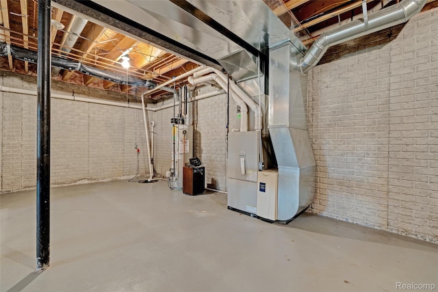333 Sherman Ct, Ortonville, MI 48462 - unfinished basement featuring gas water heater, brick wall, and heating unit