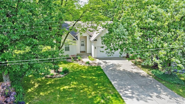 333 Sherman Ct, Ortonville, MI 48462 - view of property hidden behind natural elements featuring concrete driveway, a garage, and a front yard