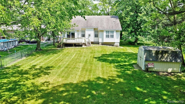 333 Sherman Ct, Ortonville, MI 48462 - back of property featuring a wooden deck, a storage shed, and a shingled roof