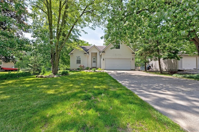 333 Sherman Ct, Ortonville, MI 48462 - view of front facade featuring driveway, an attached garage, and a front lawn