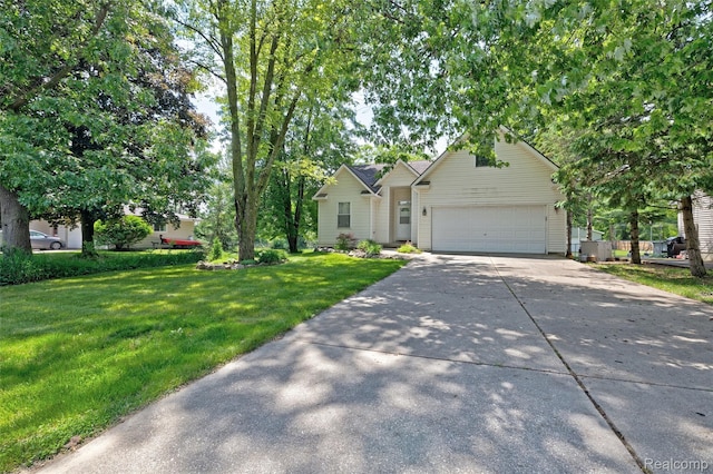 333 Sherman Ct, Ortonville, MI 48462 - view of front facade featuring driveway, a garage, and a front yard