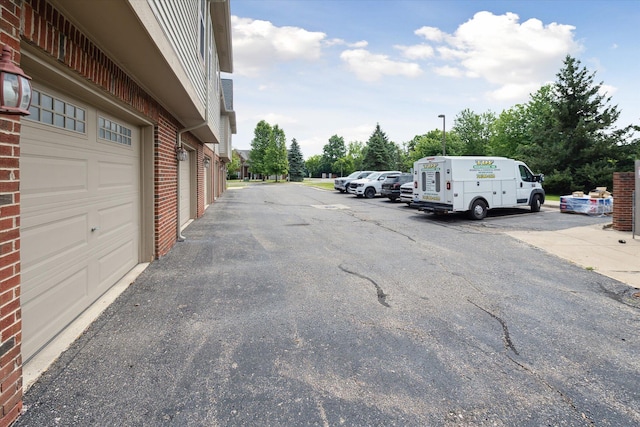 3328 Primrose Ln, Ypsilanti, MI 48197 - view of parking / parking lot featuring community garages