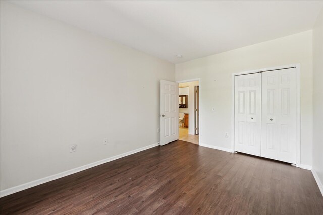 3328 Primrose Ln, Ypsilanti, MI 48197 - unfurnished bedroom featuring dark wood-type flooring and a closet