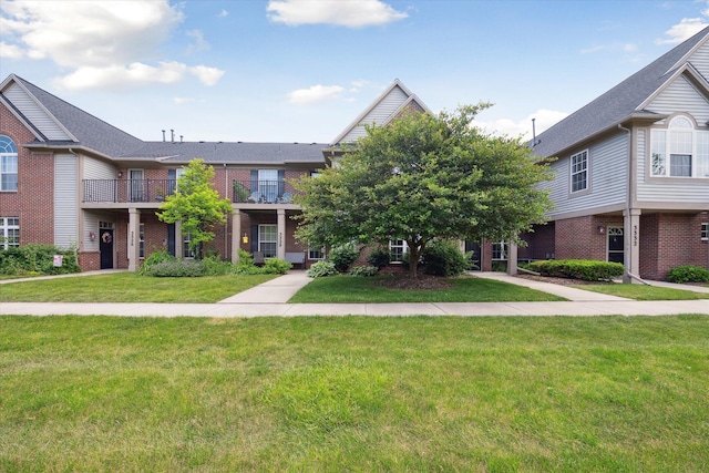 3328 Primrose Ln, Ypsilanti, MI 48197 - view of front facade with brick siding and a front lawn