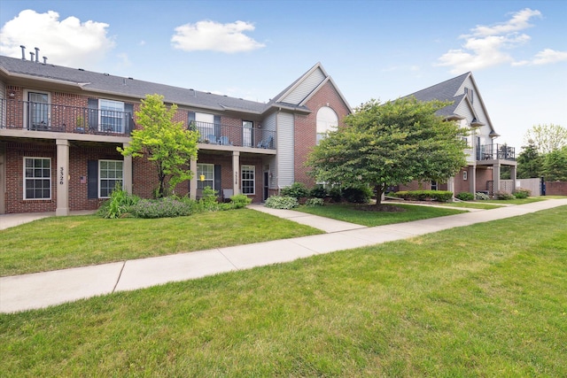 3328 Primrose Ln, Ypsilanti, MI 48197 - view of front of property with brick siding, a front lawn, and a balcony