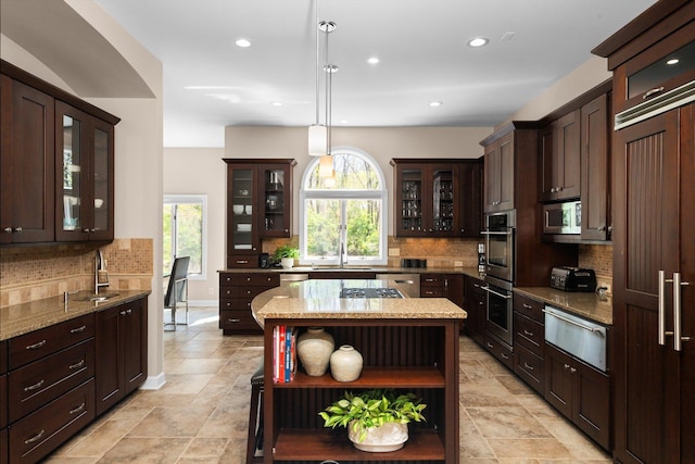 1303 Towsley Ln, Ann Arbor, MI 48105 - kitchen with open shelves, a warming drawer, tasteful backsplash, dark brown cabinetry, and plenty of natural light