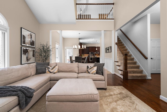1303 Towsley Ln, Ann Arbor, MI 48105 - living area featuring dark wood-type flooring, a chandelier, stairway, and a towering ceiling