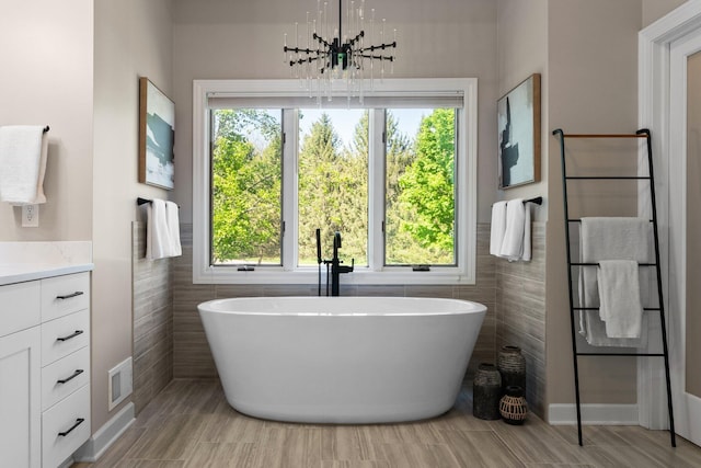 1303 Towsley Ln, Ann Arbor, MI 48105 - bathroom featuring a freestanding bath, plenty of natural light, and tile walls