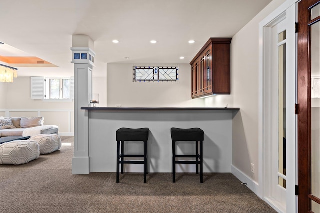 1303 Towsley Ln, Ann Arbor, MI 48105 - kitchen with dark carpet, glass insert cabinets, a kitchen breakfast bar, recessed lighting, and dark countertops