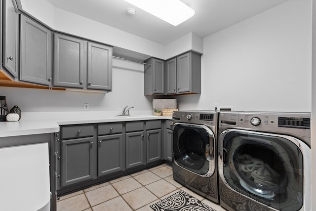 1303 Towsley Ln, Ann Arbor, MI 48105 - laundry room with washing machine and clothes dryer, cabinet space, and light tile patterned flooring