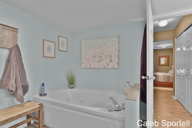 3360 Pine Meadow Dr SE Unit 202, Kentwood, MI 49512 - ensuite bathroom featuring a jetted tub and wood finished floors