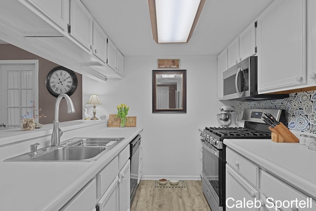 3360 Pine Meadow Dr SE Unit 202, Kentwood, MI 49512 - kitchen featuring stainless steel appliances, white cabinets, light countertops, and decorative backsplash