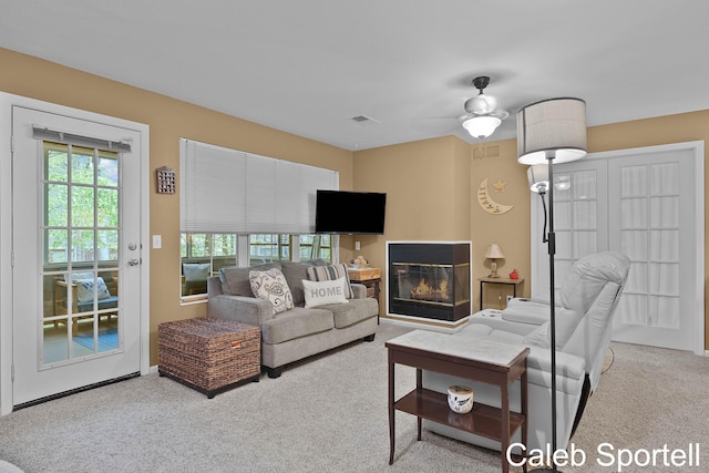 3360 Pine Meadow Dr SE Unit 202, Kentwood, MI 49512 - living room with carpet floors, a glass covered fireplace, and ceiling fan