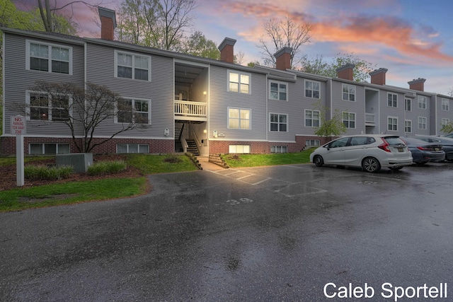 3360 Pine Meadow Dr SE Unit 202, Kentwood, MI 49512 - property at dusk with uncovered parking and stairs