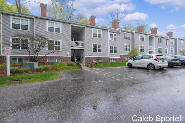 3360 Pine Meadow Dr SE Unit 202, Kentwood, MI 49512 - view of property featuring uncovered parking