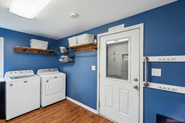 9669 Norman Rd, Clarkston, MI 48348 - washroom featuring washing machine and dryer and wood finished floors