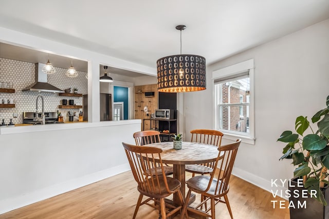 1624 Boston St SE, Grand Rapids, MI 49506 - dining area featuring light wood-type flooring and baseboards