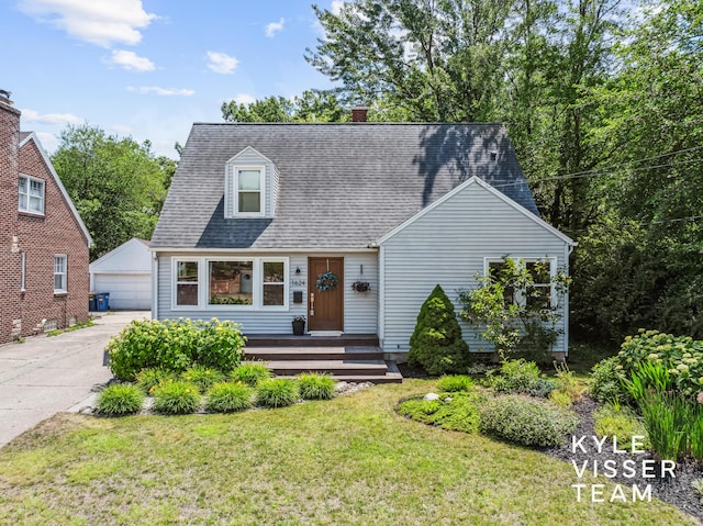 1624 Boston St SE, Grand Rapids, MI 49506 - cape cod house featuring an outdoor structure, a front lawn, a detached garage, roof with shingles, and a chimney