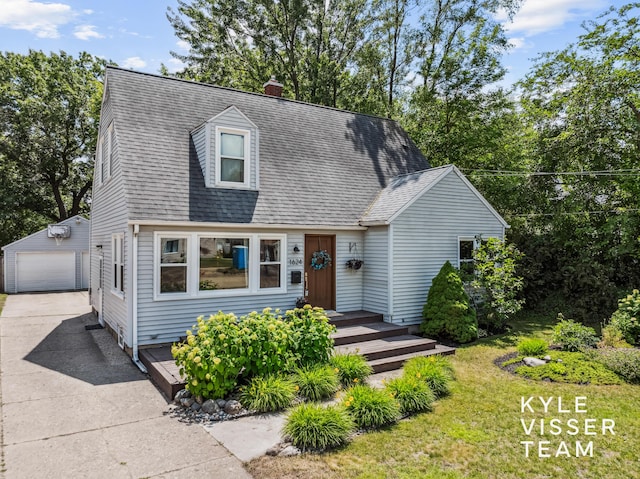 1624 Boston St SE, Grand Rapids, MI 49506 - new england style home with an outbuilding, a garage, a chimney, and a shingled roof