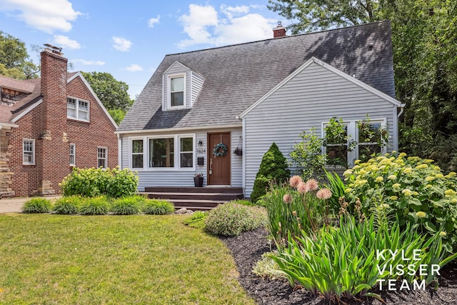 1624 Boston St SE, Grand Rapids, MI 49506 - cape cod home featuring a front lawn and roof with shingles