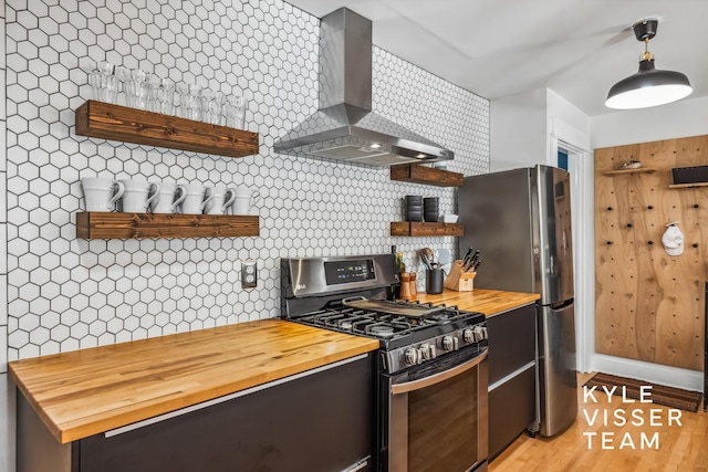 1624 Boston St SE, Grand Rapids, MI 49506 - kitchen featuring appliances with stainless steel finishes, wall chimney range hood, open shelves, wood counters, and backsplash