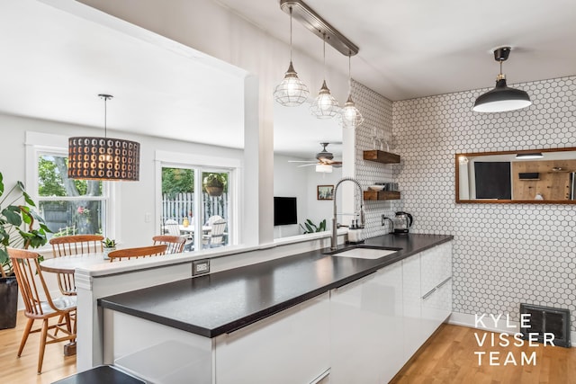 1624 Boston St SE, Grand Rapids, MI 49506 - kitchen with open shelves, white cabinetry, dark countertops, and healthy amount of natural light