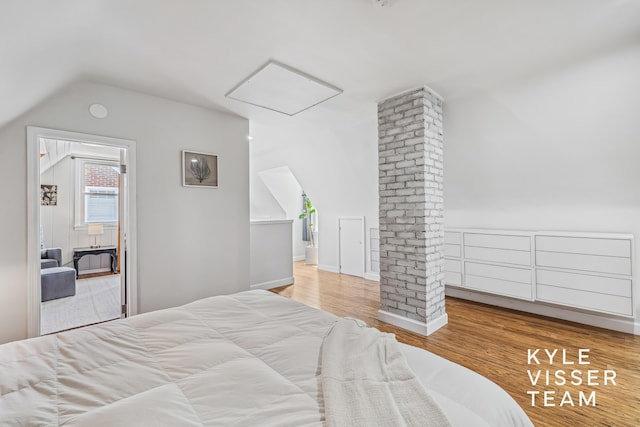 1624 Boston St SE, Grand Rapids, MI 49506 - bedroom featuring vaulted ceiling, wood finished floors, and attic access