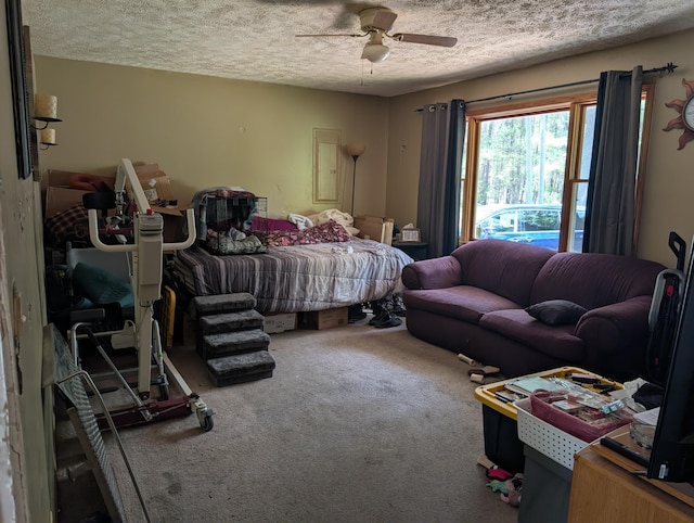 197 E Cedar Rd, Twin Lake, MI 49457 - carpeted bedroom featuring a textured ceiling and a ceiling fan