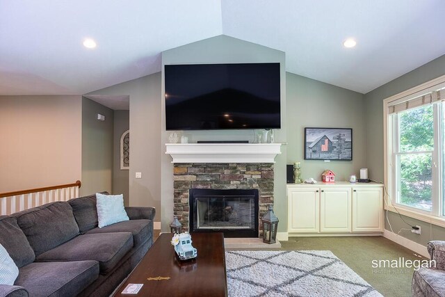 3440 Monterey Hills Dr NE, Grand Rapids, MI 49525 - carpeted living area with vaulted ceiling, plenty of natural light, a stone fireplace, and recessed lighting