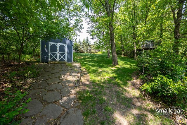 3440 Monterey Hills Dr NE, Grand Rapids, MI 49525 - view of green lawn featuring a storage shed