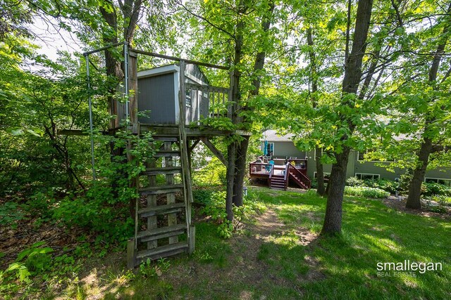 3440 Monterey Hills Dr NE, Grand Rapids, MI 49525 - view of green lawn with a wooden deck and stairway
