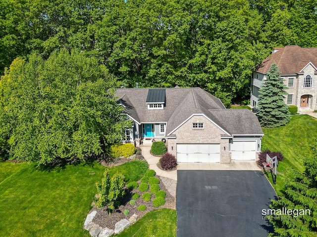 3440 Monterey Hills Dr NE, Grand Rapids, MI 49525 - view of front facade with asphalt driveway, an attached garage, and a front lawn