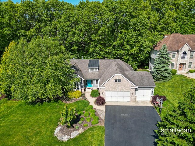 3440 Monterey Hills Dr NE, Grand Rapids, MI 49525 - view of front of home featuring driveway, a front yard, and a garage