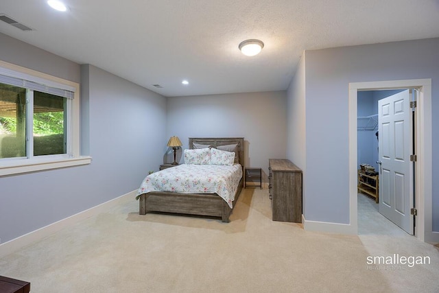 3440 Monterey Hills Dr NE, Grand Rapids, MI 49525 - carpeted bedroom with recessed lighting and a walk in closet